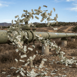 Pipeline with dollar bills flowing out representing financial waste or loss